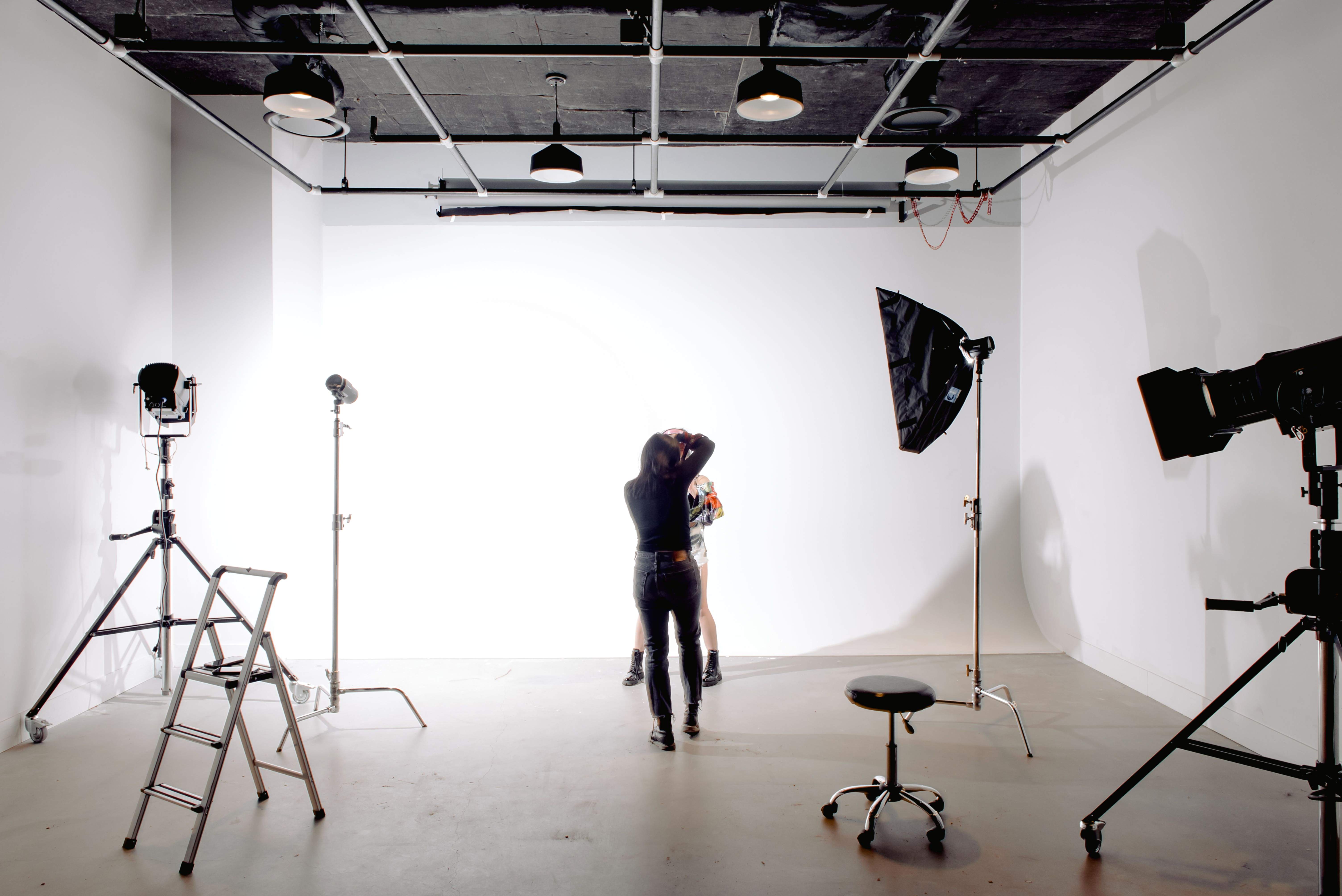 Professional photographer setting up a portrait shoot in a London photography studio