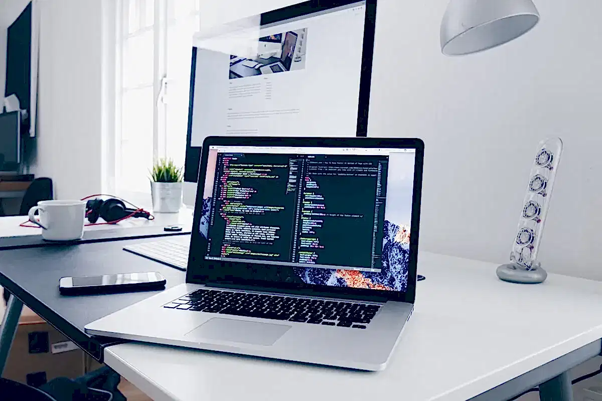 Web designer developing a custom London business website on a professional laptop workspace