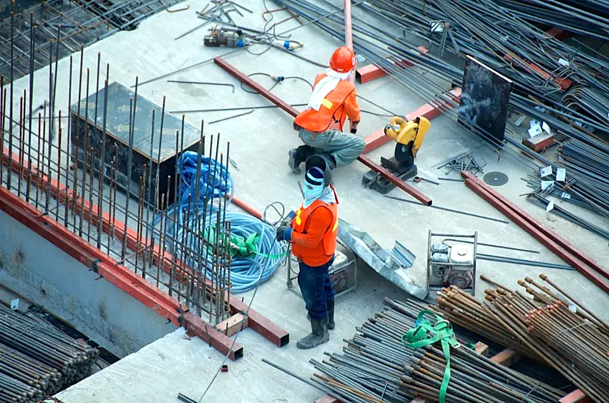 London construction project site with contractor team reviewing architectural plans.